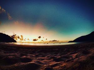 a view of a beach with the sun setting at Tiongman Scubadive & Lodge in Tioman Island