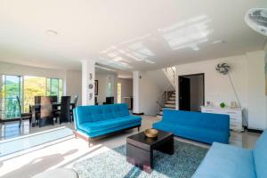 ein Wohnzimmer mit 2 blauen Sofas und einem Tisch in der Unterkunft Villa Roca, Rodadero in Santa Marta