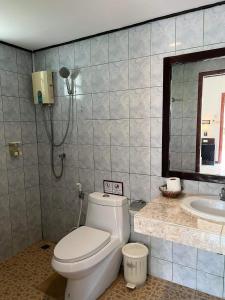 a bathroom with a toilet and a sink at Golden Bay Cottage - SHA Extra Plus in Ko Lanta