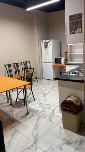 a kitchen with a table and chairs and a refrigerator at Mega Hostel in Almaty +15 photos