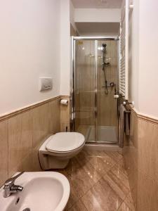 a bathroom with a shower and a toilet and a sink at La casa di Soddy in Albano Laziale +7 photos