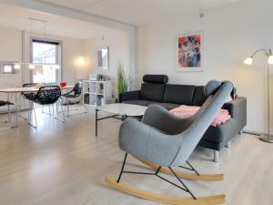 a living room with a couch and a chair at Apartment Mirija - 2-3km from the sea in Western Jutland by Interhome in Havneby