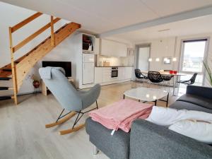 a living room with a couch and a table at Apartment Mirija - 2-3km from the sea in Western Jutland by Interhome in Havneby