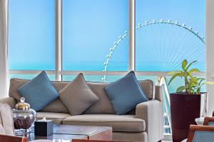 a living room with a couch with blue pillows at Blue Beach Tower The Walk JBR in Dubai