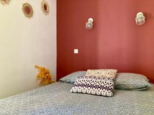a bedroom with a bed and a red wall at Les Restanques vue mer 2148 in Grimaud +22 photos