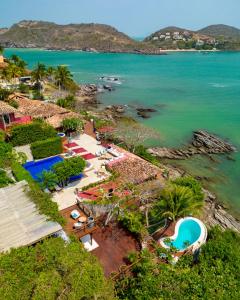 an aerial view of a resort and the ocean at Insólito Boutique Hotel & Spa in Búzios