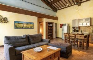 a living room with a couch and a table at Il Vecchio Mulino Toscana in Radicondoli