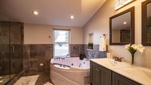 a bathroom with a tub and a sink and a mirror at Cheerful 5-bedroom w/Screened Patio, Sleeps 10 in the heart of Fremont! in Fremont