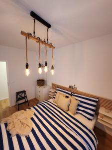 a bedroom with a bed with blue and white stripes at Mickey Apartment Old Town in Bratislava