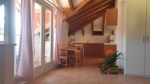 a kitchen with a table and a dining room at Caffè del Viaggiatore in Valsolda