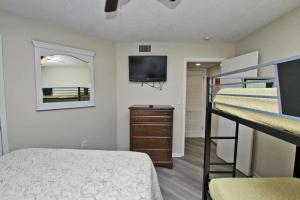 1 dormitorio con 2 literas y TV en Gulf Shores Plantation 1143, en Gulf Highlands