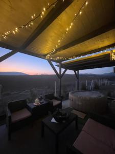 a living room with a view of the desert at sunset at NatureZone in Eger
