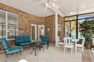 a living room with blue chairs and a table at Sunset Pass in Middleburg