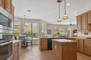 a kitchen with wooden cabinets and a dining room at Sunset Pass in Middleburg