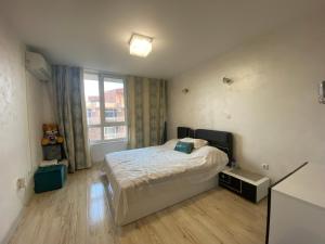 a bedroom with a bed and a large window at ANITA B19 LUXORY Apartment Sunny Beach in Sunny Beach