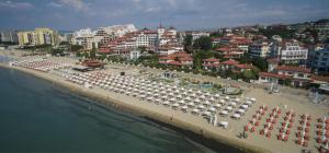 a beach with a lot of umbrellas and a city at ANITA B19 LUXORY Apartment Sunny Beach in Sunny Beach