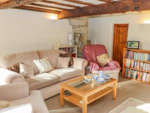 a living room with a couch and a coffee table at Trickett Gate Cottage in Castleton