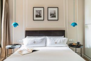 Rental Apartment Barcelona في برشلونة: غرفة نوم بسرير بثلاث صور على الحائط