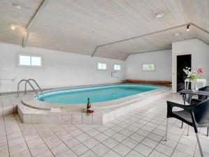a large swimming pool in a large room with at Holiday Home Madalena - 2-8km from the sea in Western Jutland in Toftum