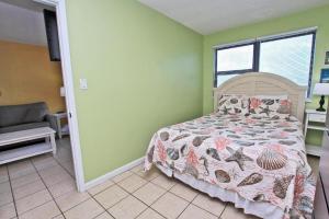 - une chambre avec un lit et un canapé dans l'établissement Island Shores 457, à Gulf Shores