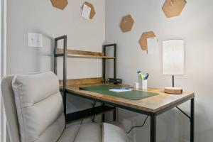 a desk in a room with a chair and a desk with a lamp at The Den at The Ravines in Middleburg