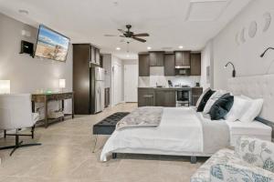 a bedroom with a large bed and a kitchen at The Den at The Ravines in Middleburg