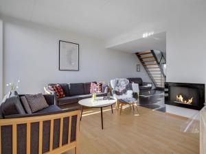 a living room with a couch and a fireplace at Apartment Pirkko - 100m from the sea in Western Jutland by Interhome in Havneby