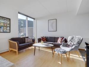 a living room with a couch and a table at Apartment Pirkko - 100m from the sea in Western Jutland by Interhome in Havneby
