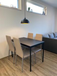 a dining room table with chairs and a couch at Moderne Wohnung in Heskem bei Marburg (Lahn) 