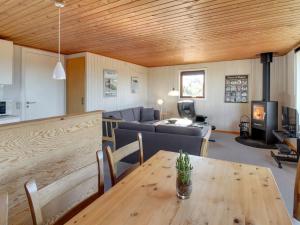 een woonkamer met een tafel en een bank bij Holiday Home Sara - 2-5km from the sea in Western Jutland by Interhome in Bolilmark