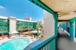 a view from a balcony of a hotel with a swimming pool at Sea Breeze #312 in Gulf Shores