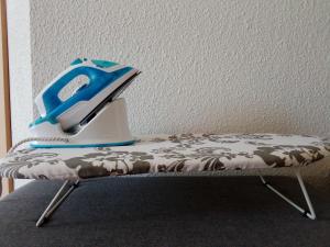 a iron is sitting on top of a bench at Studio calme, proche centre, Wifi. in Belfort