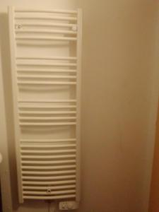 a closet with white shelving in a room at Studio calme, proche centre, Wifi. in Belfort