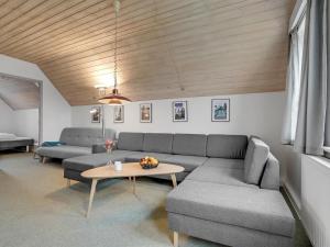 a living room with a couch and a table at Apartment Efraima - 1-7km from the sea in Western Jutland by Interhome in Sønderby
