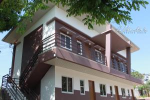 a house with a balcony in front of it at Alberto's Lodging House in Mariveles