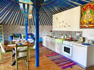 a kitchen with a tent with a table and a stove at Exclusive Nirvana yurts Glamping in Kato Drys