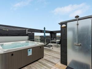 a hot tub on the deck of a house at Holiday Home Leto - 2km from the sea in Western Jutland by Interhome in Havneby