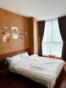 Postel nebo postele na pokoji v ubytování LaLa Homestay