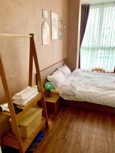 a small bedroom with a bed and a window at LaLa Homestay in Hue