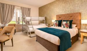 a bedroom with two beds and a desk and a chair at Breaffy House Hotel and Spa in Castlebar