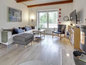 a living room with a couch and a table at Holiday Home Ridir - 3-5km from the sea in Western Jutland by Interhome in Rømø Kirkeby