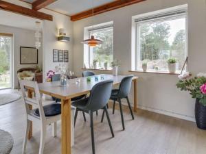 a dining room with a table and chairs at Holiday Home Ridir - 3-5km from the sea in Western Jutland by Interhome in Rømø Kirkeby
