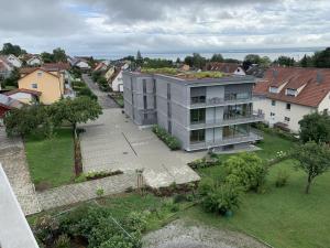 an aerial view of a building in a city at Trilogie am See Wohnung Taube in Stetten