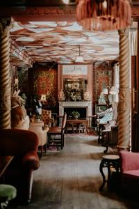 a room with tables and chairs and a fireplace at The Zetter Clerkenwell in London