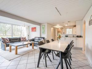 a kitchen and living room with a table and chairs at Holiday home Oksbøl LVII in Oksbøl