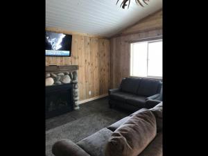 a living room with a couch and a fireplace at Family Cabin Unit 7 in Rea