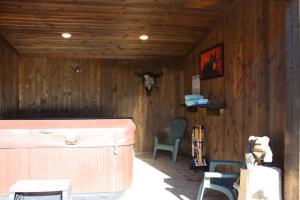 a wooden room with two chairs and a table at Family Cabin Unit 10 in Rea