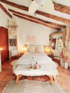 a bedroom with a large bed with two apples on it at La Ultima Casa Masboquera in Mas Boquera