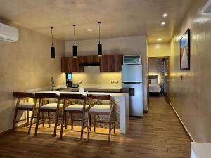 a kitchen with a table and chairs and a refrigerator at New apartment with all services and pool Marcos #1 in Isla Mujeres