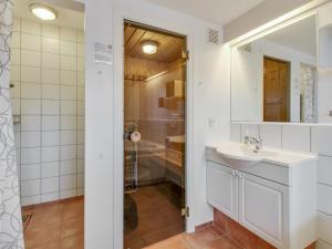 a bathroom with a sink and a shower at Apartment Guthir - 1-2km from the sea in Western Jutland by Interhome in Blåvand